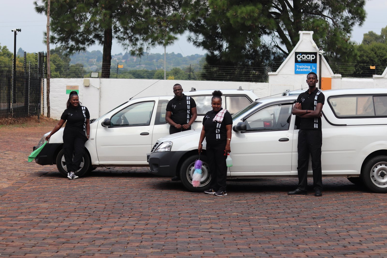 The SparklePro cleaning team with their vehicles